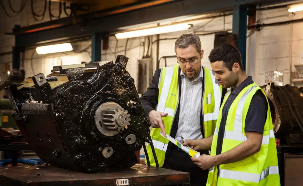 Houghton International's CEO and Apprentice with traction motor